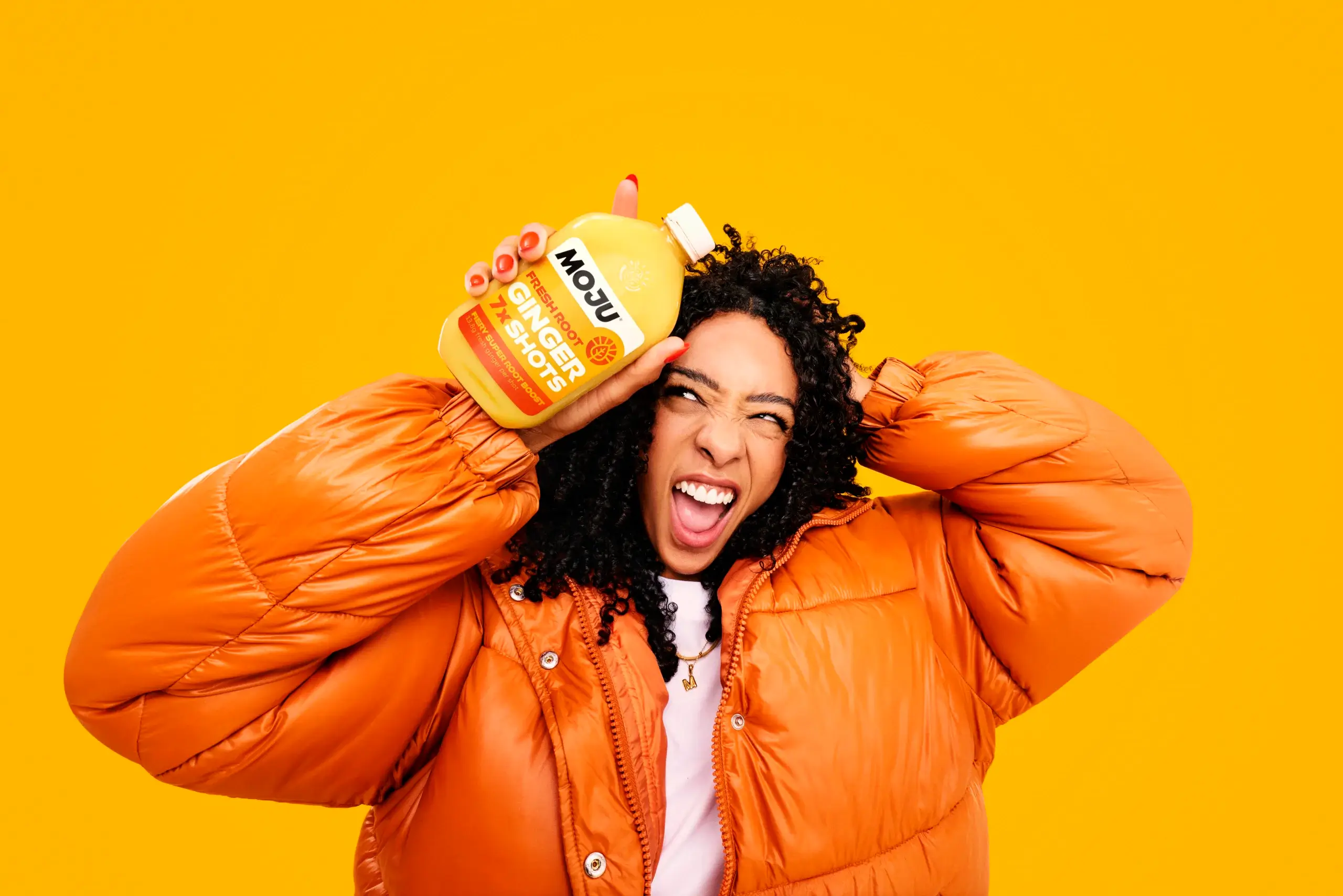 Image of a person enjoying a MOJU shot, representing the brand's commitment to human rights and environmental impact